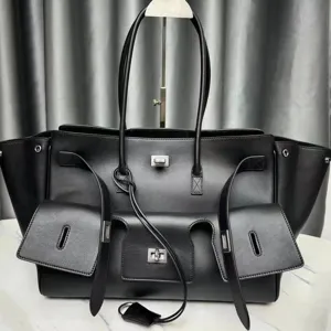 Luxury black leather tote bag with multi pockets and winged design for women commuters.