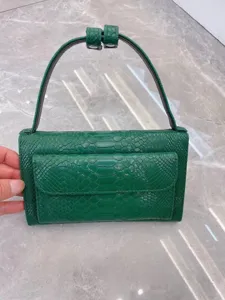 Green embossed leather shoulder bag for women, trendy underarm baguette bag with top handle.