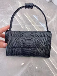Black snakeskin texture baguette shoulder bag, chic women's small handbag with flap design.