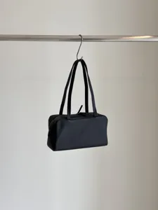 Minimalist black leather shoulder bag, elegant boston bowling design with dual straps for women.