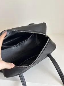Black leather bowling bag for women, large capacity minimalist shoulder and boston handbag.
