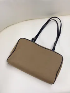 Canvas shoulder bag with black leather trim, stylish horizontal boston handbag for women.