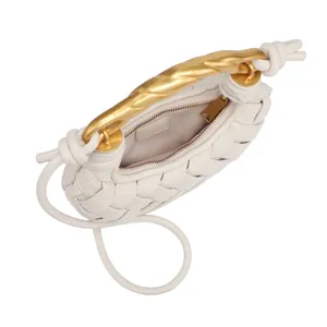 Mini white woven leather handbag with gold twisted metal handle, detailed top view shot.