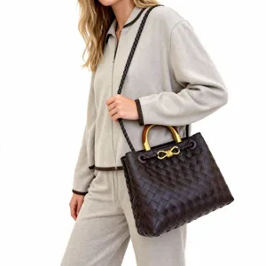 Classic woven leather tote bag with metal handle and shoulder strap for daily commute.