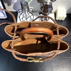 Brown woven leather tote bag with wooden handle and metal knot, large capacity shoulder bag.