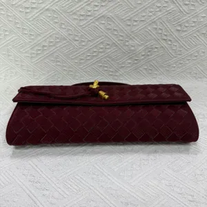 Burgundy woven leather clutch bag with elegant metal knot closure, stylish evening purse for women.