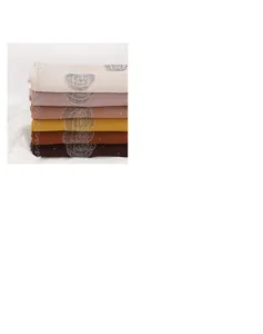 Detail view of stylish chiffon hijab scarves stack with rhinestone rose patterns in multi colors.