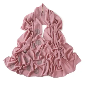 Elegant dusty pink chiffon hijab scarf with rhinestone spiral patterns and sparkly edges.