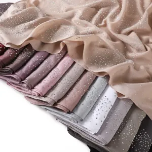 Detailed closeup view of shimmering rhinestone chiffon hijab scarf showing rich fabric and color stack.