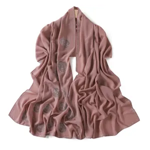 Dusty pink chiffon hijab scarf with rhinestone rose embellishments and elegant draped design.