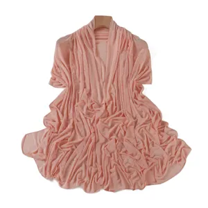 Detailed view of pink rhinestone mesh shawl fabric, sparkling rhinestones on sheer lightweight fabric.