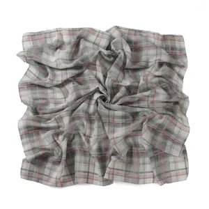 Detail view of a retro British style plaid square scarf, showing the lightweight chiffon texture.