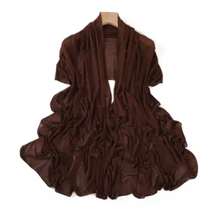 Details of the dark brown mesh shawl featuring delicate hot-drill rhinestones for elegant styling.