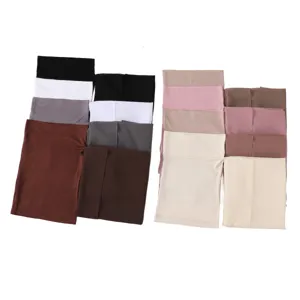 Close-up view of solid color chiffon scarves and inner caps in multi-color options.