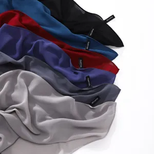Close-up detail of solid color chiffon long scarves, showing soft texture and neat edges.