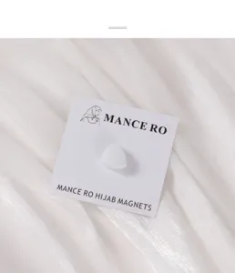 Gedetailleerd weergave van witte matte driehoek magnetische hijab clip voor sjaals.