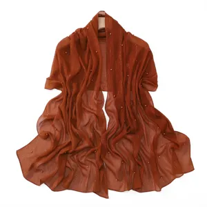 Rust pleated chiffon shawl with metallic threads and scattered pearls for elegant women's wear.