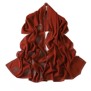 Detailed view of the red chiffon hijab scarf featuring exquisite rhinestone spiral design.