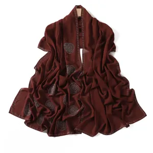 Sparkling rhinestone red chiffon hijab scarf detail showing delicate crystal patterns.