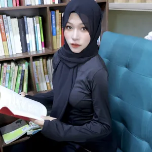 Close-up detail of the elegant black chiffon hijab and matching inner cap worn by model.