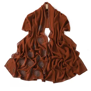 Close-up view of the brown rhinestone chiffon hijab, showing delicate hot-drill patterns.