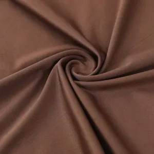 Brown milk silk fabric swirl detail close up, soft smooth textile texture for headscarf