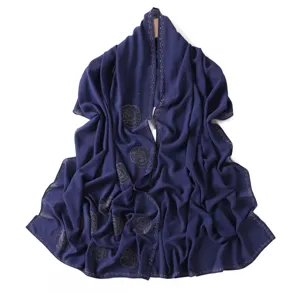 Detailed view of the dark blue rhinestone embellished chiffon scarf showcasing texture and sparkle.