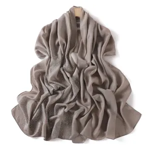 Detailed view of grey-brown chiffon rhinestone scarf glitter sparkle shawl wrap fabric texture.