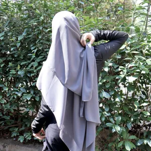 Solid color chiffon hijab detail shot showing graceful draping and elegant fabric texture.