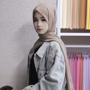 Detailed view of the solid chiffon hijab and inner cap set worn by model in studio.