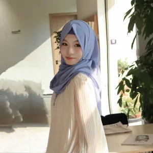 Detailed closeup of the pleated chiffon hijab and matching inner cap set in a soft indoor setting.