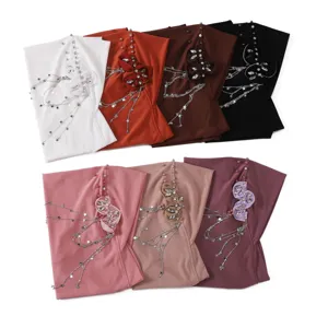 Comfortable solid color hijab turban with rhinestone flower and star tassel chain for women.