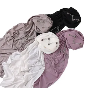 Solid color turban hijab with rhinestone camellia and tassel chain, comfortable head wrap.