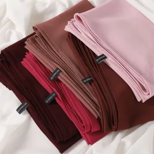 Solid color chiffon hijab scarf detail showing soft polyester fabric texture and folded layers.