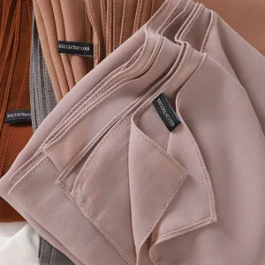 Close-up detail of solid color chiffon hijab scarf showing neat stitching and soft fabric texture.