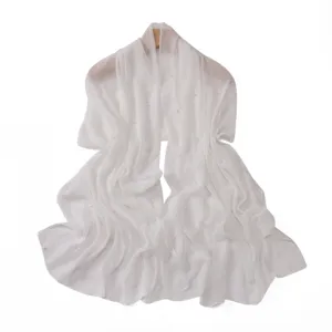 White chiffon scarf detail, featuring shimmering silver threads and delicate pearl embellishments.