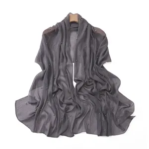 Elegant grey pleated chiffon scarf featuring shimmering silver threads and delicate pearl beading.
