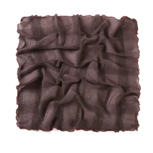 Detail view of the crinkled square scarf texture, showcasing soft fabric and delicate ruffle edge.