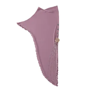 Close-up detail of the dusty rose crystal linen headscarf with delicate pearls and floral decor.