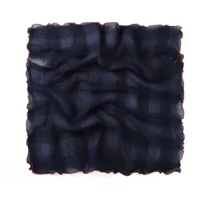 Detailed view of the pleated navy blue square scarf with contrast lettuce edge design.