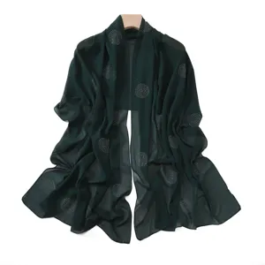 Dark green chiffon scarf detail with sparkling rhinestone polka dot patterns and elegant drape.
