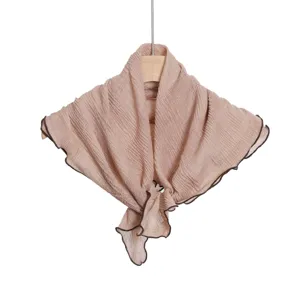 Detailed view of the crinkled square scarf with lettuce edge hanging on a wooden hanger.