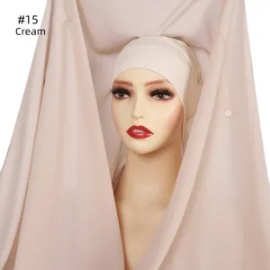 Detail view of the elegant cream chiffon hijab scarf and matching inner cap accessories.