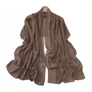 Brown chiffon rhinestone scarf detail, elegant circle pattern close-up display.