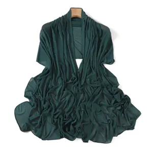 Detail shot of dark green sparkly rhinestone stretch mesh shawl and women thin wrap scarf.