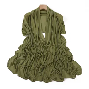 Olive green mesh shawl detail showing delicate rhinestone sparkles and fine ruched texture.