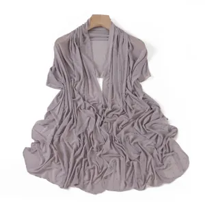 Detailed view of the sheer stretch mesh shawl with subtle rhinestone studs in taro purple.