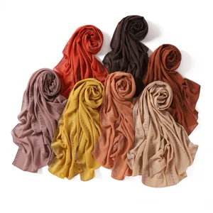 Detailed view of fashionable chiffon rhinestone chain hijab scarf, elegant Muslim long shawl.