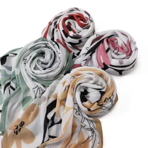 Detailed view of pleated chiffon floral doodle scarves showcasing vibrant colors and soft texture.