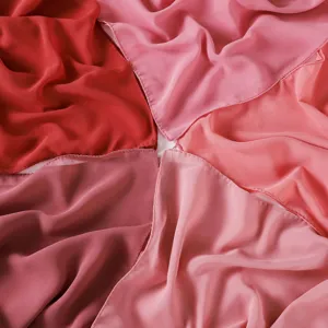 Detailed close-up showing soft chiffon fabric texture and rich pink and red color shades.